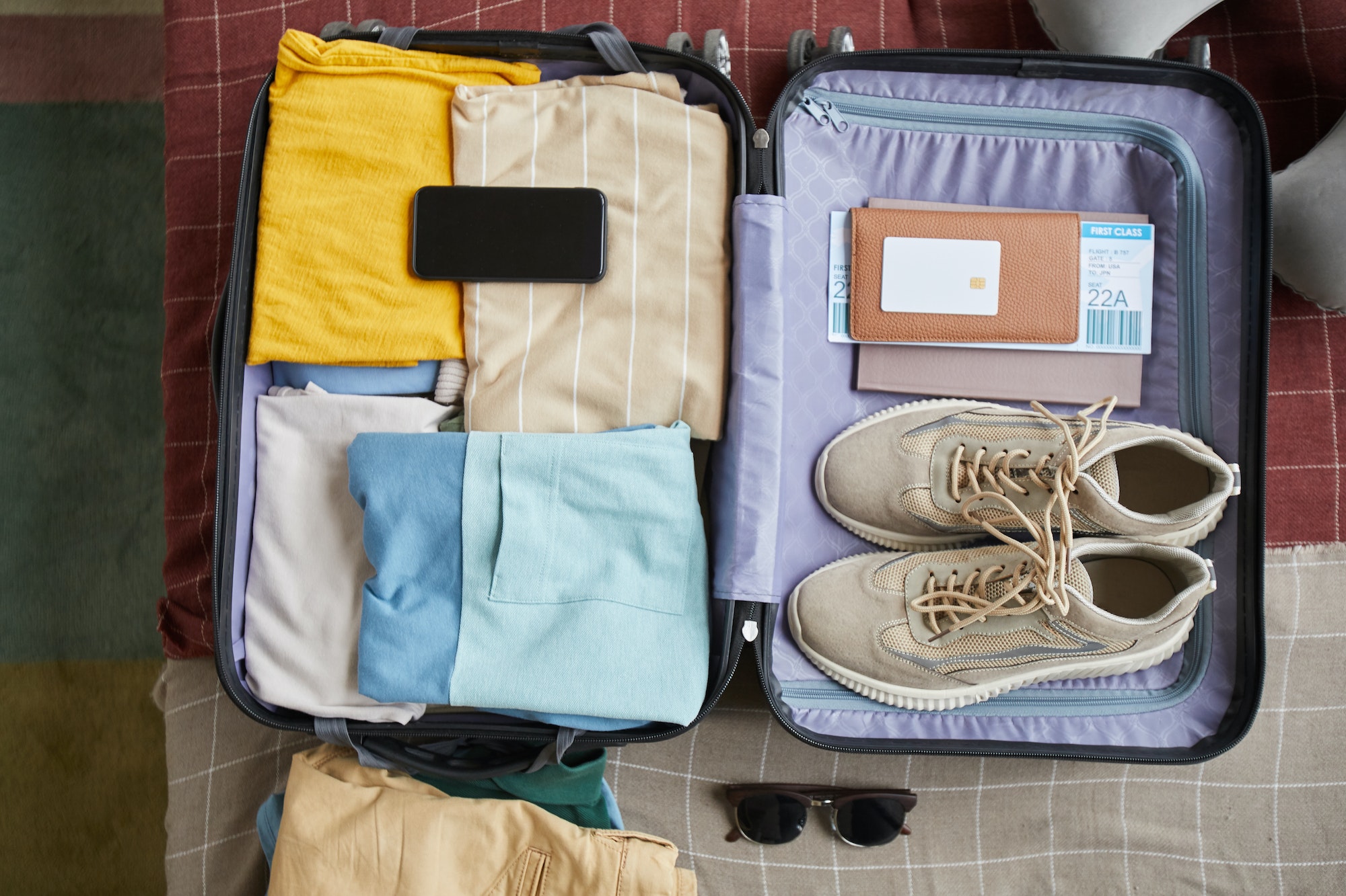 Clothes with documents in suitcase